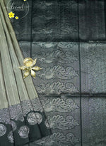 LSK6130 Silver-Grey silk saree with black pallu richly woven with large, intricate silver zari peacock motifs.