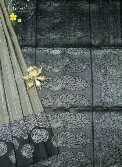 LSK6130 Silver-Grey silk saree with black pallu richly woven with large, intricate silver zari peacock motifs.
