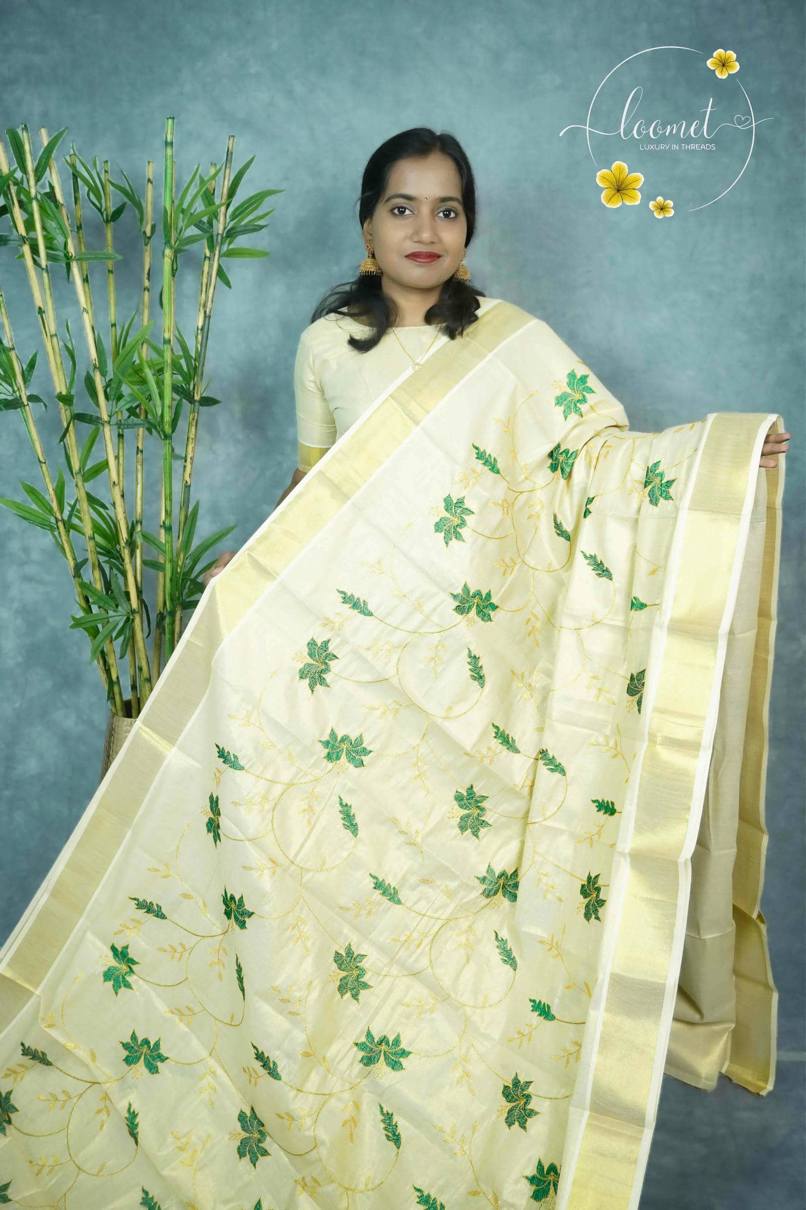 MKF3262 Cream saree features a golden border and vibrant green leaf embroidery scattered across the entire fabric.