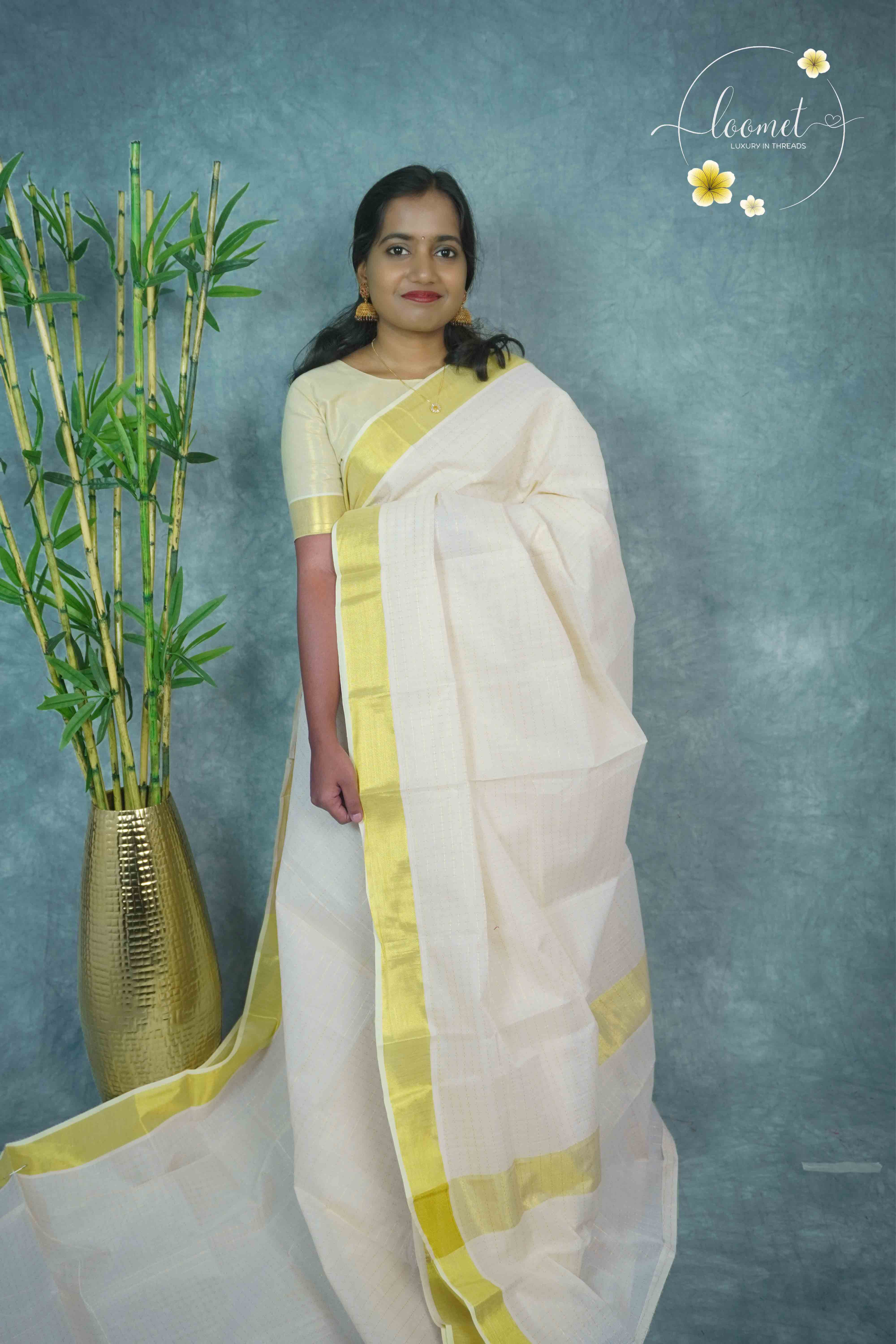 MKF3280 Off-white Kerala cotton saree featuring a minimalist check pattern and a striking traditional golden zari border and pallu.