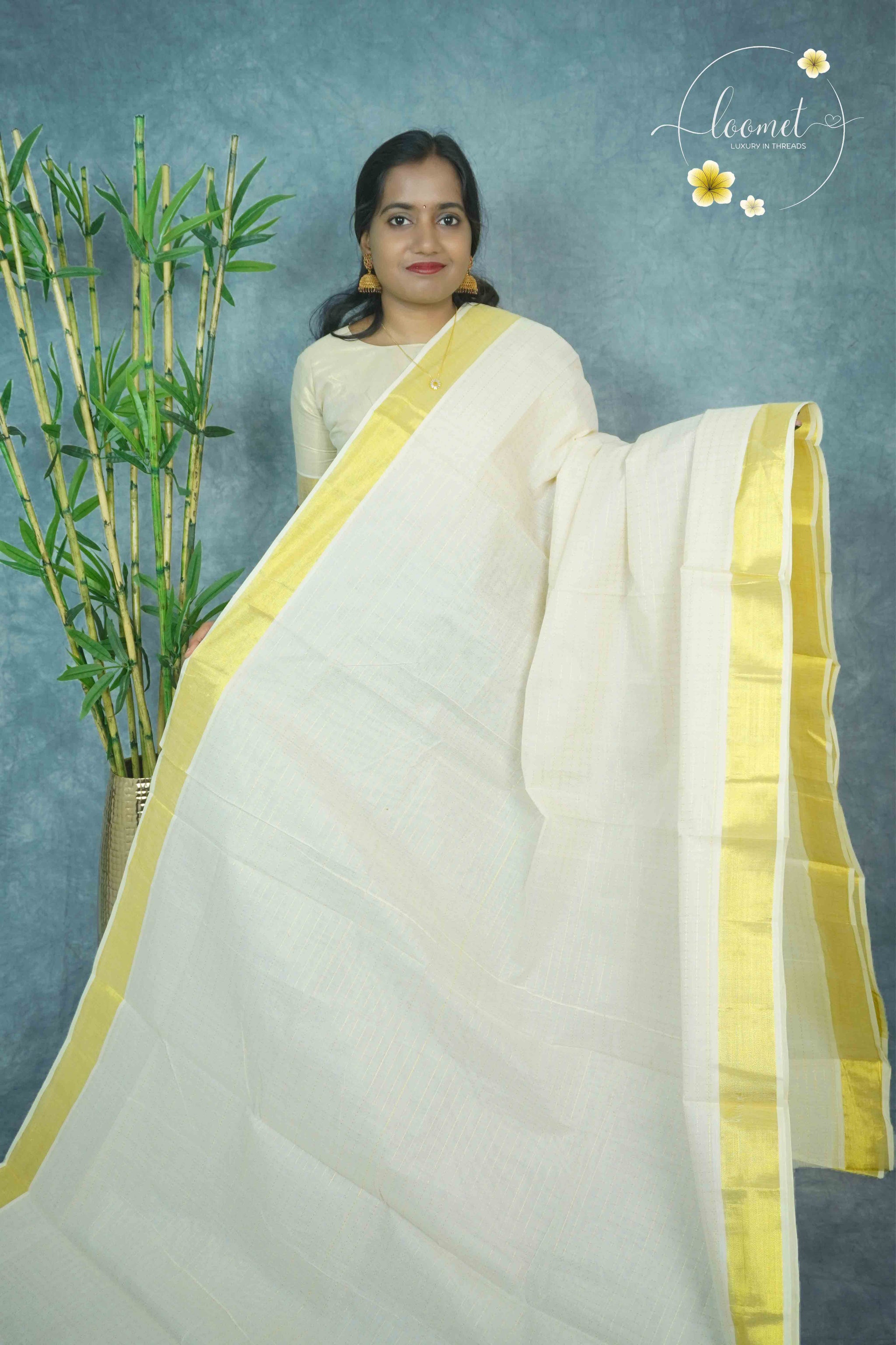MKF3280 Off-white Kerala cotton saree featuring a minimalist check pattern and a striking traditional golden zari border and pallu.