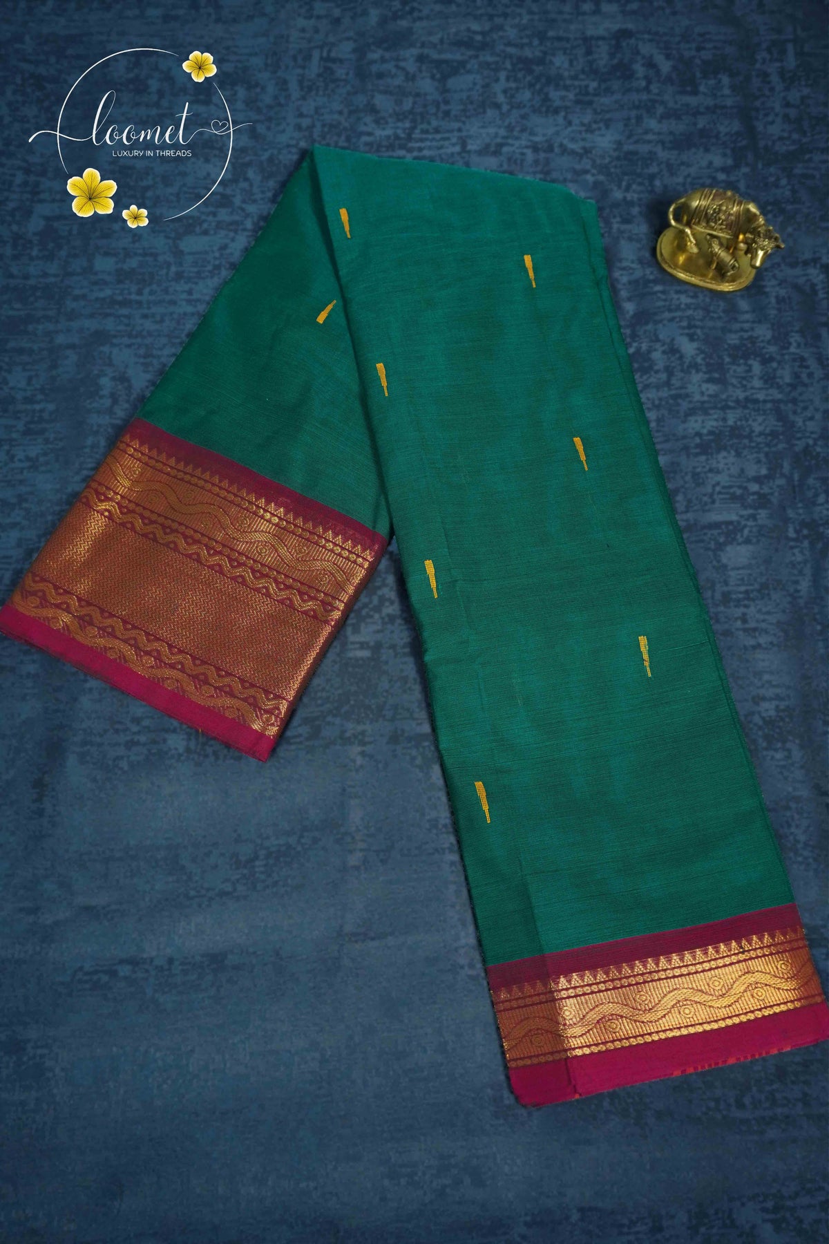 MPS1650 Emerald Green Kanchi cotton saree with gold zari buttas and wavy pattern.