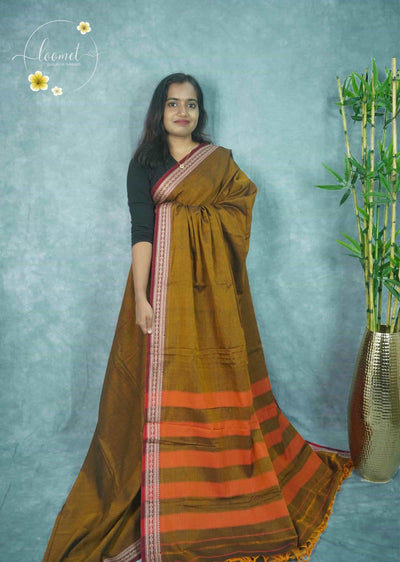 NLS1118 Mustard-brown saree features a solid body and a contrasting maroon border with cream paisley and geometric patterns.