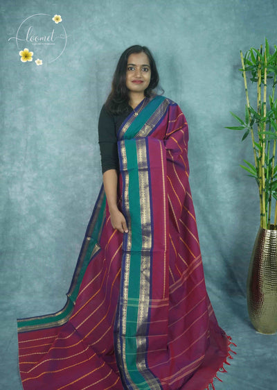 NLS5212 Maroon saree features intricate gold patterned stripes and a multi-colored border with traditional zari peacock and floral circular motifs.