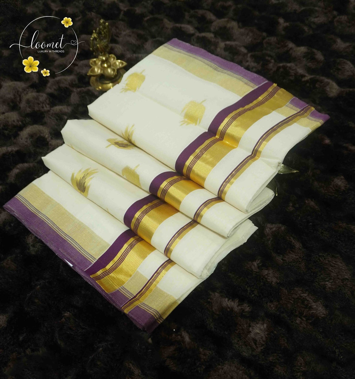 RKT2002 Off-White Balaramapuram Handloom saree with rich purple borders and golden zari buttas.