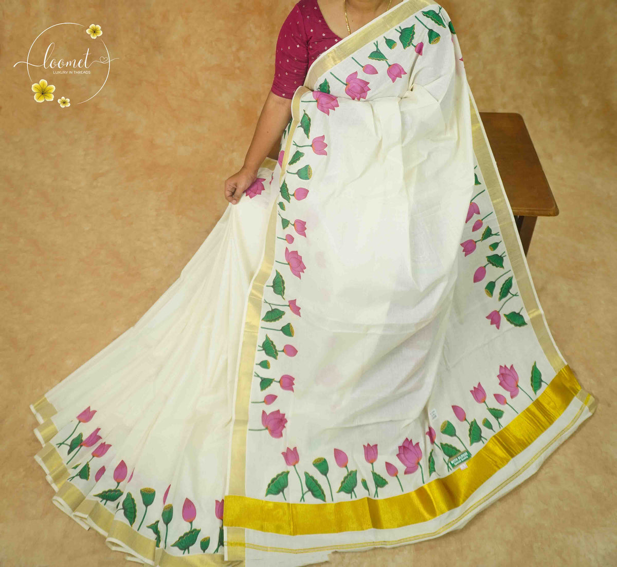 RKT2131 Off-White Kerala Cotton saree with lotus vine border and golden kasavu accents.