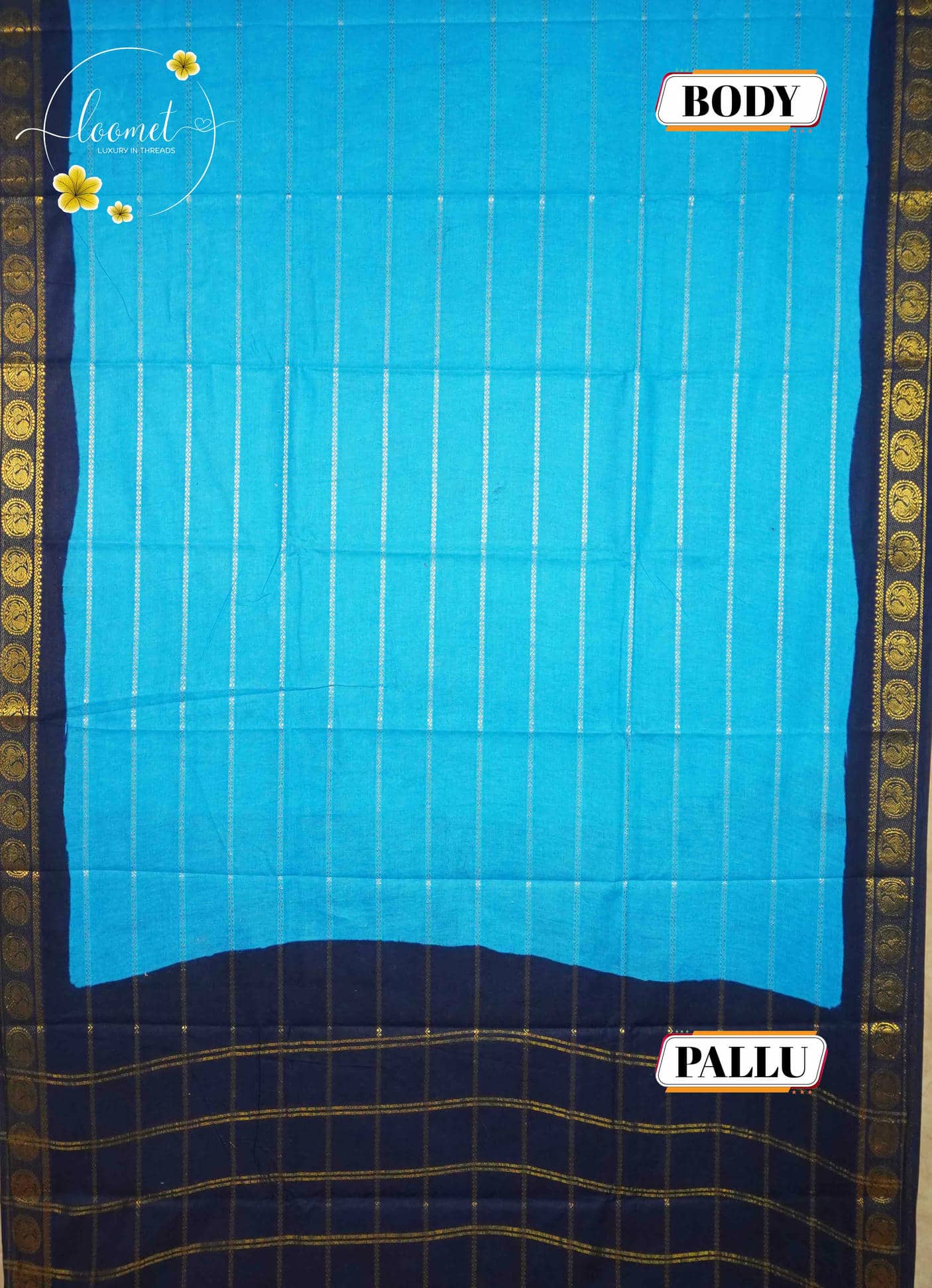 SPT3143 Sky blue saree with horizontal gold zari stripes on the body with antique gold brocade peacock motifs on a solid navy blue base.